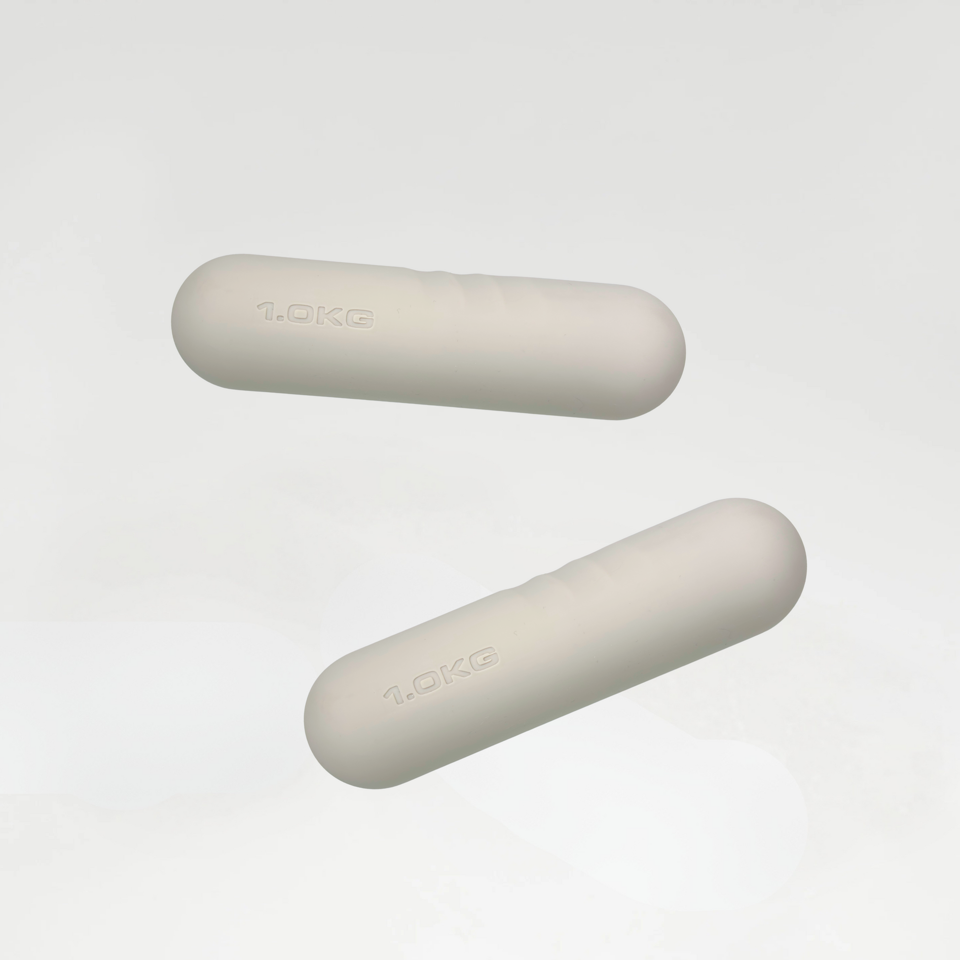 Pair of 1 kg ivory dumbbells with a smooth matte finish, designed for light strength training and home workouts.